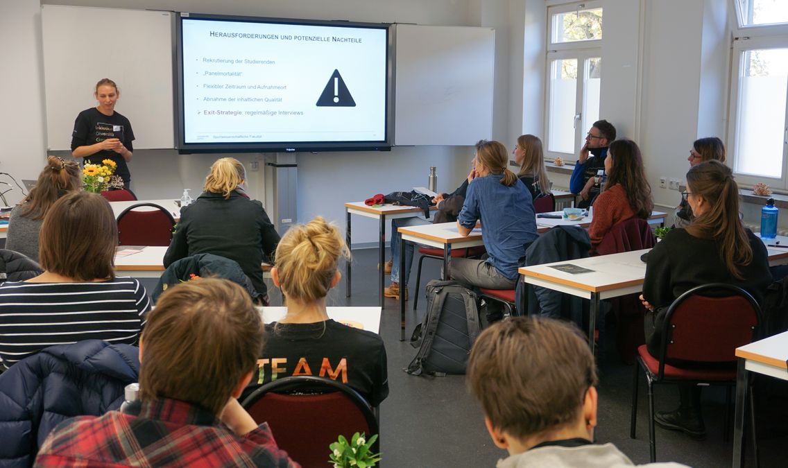 zur Vergrößerungsansicht des Bildes: Auf dem Bild ist Greta Engelke bei der Präsentation ihres Promotionsvorhabens auf der Nachwuchstagung zu sehen.