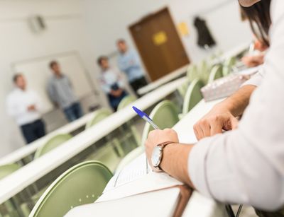 Studierende verschwommen im Hintergrund im Seminarraum, Foto: Christian Hüller