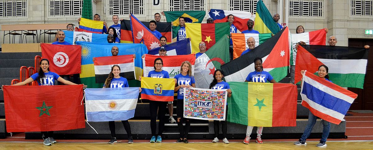 zur Vergrößerungsansicht des Bildes: Gruppenfoto der Teilnehmenden des ITK-Ambassador-Meetings 2017 mit Länderflaggen